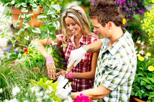 Trained gardeners using protective equipment in Lower Morden